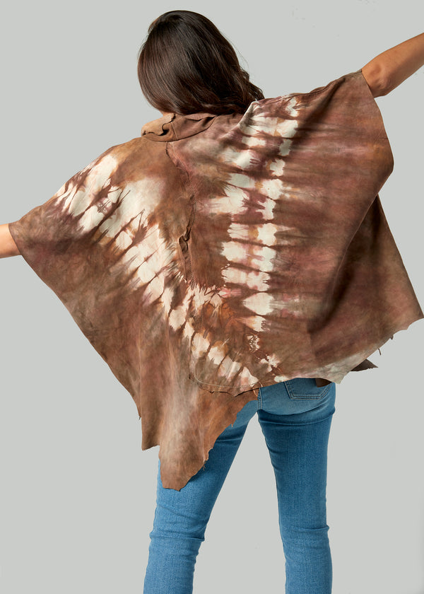 Back view of tie-dye leather poncho in a V pattern with earthy tones.